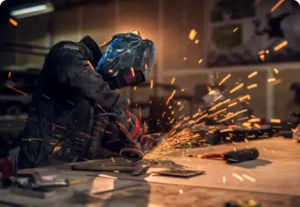 Craftsman Sawing Metal Sparkles Around Workshop